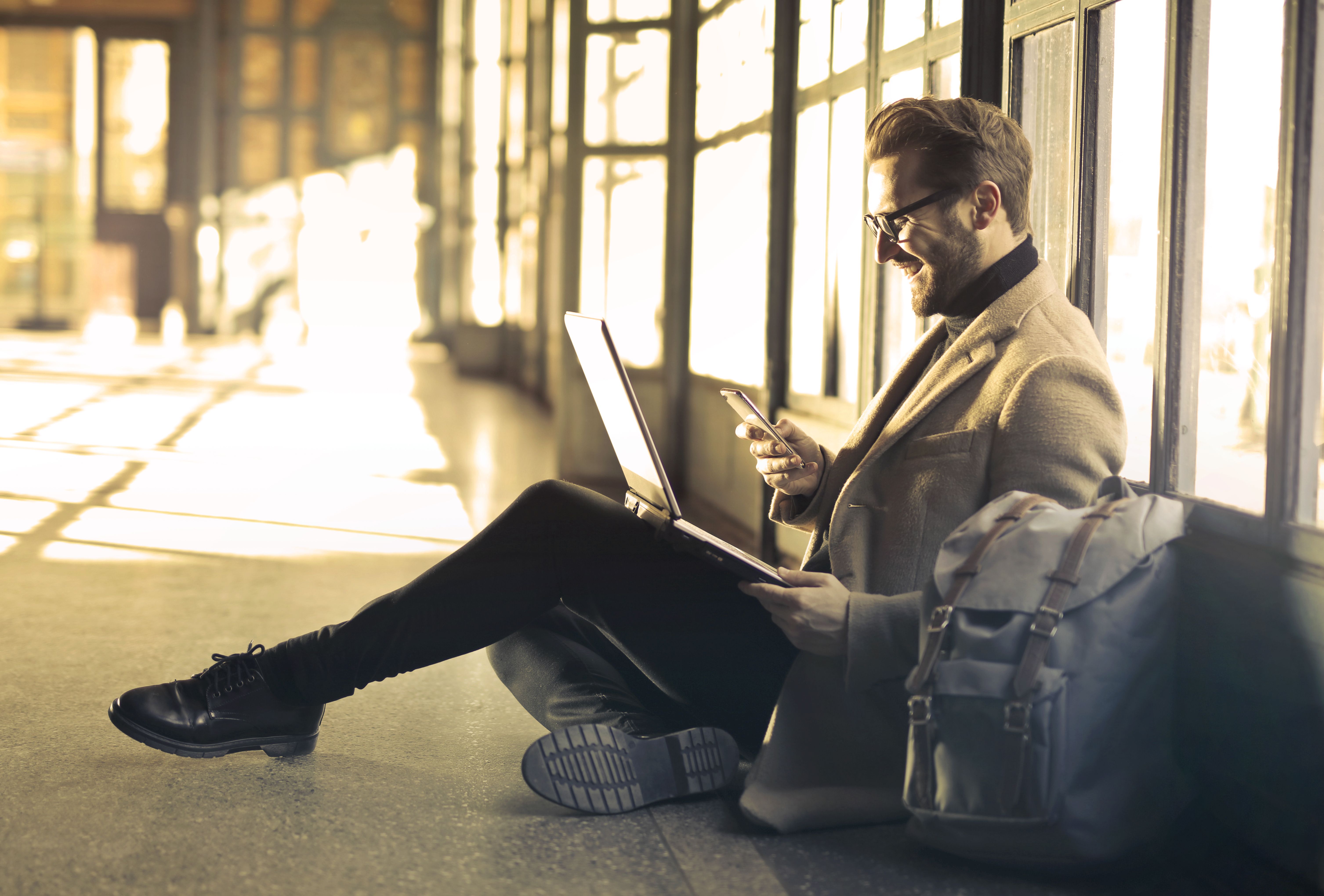 Traveler using a phone in an airport before departure